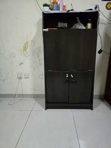 Compact dark wood storage cabinet with lockable doors