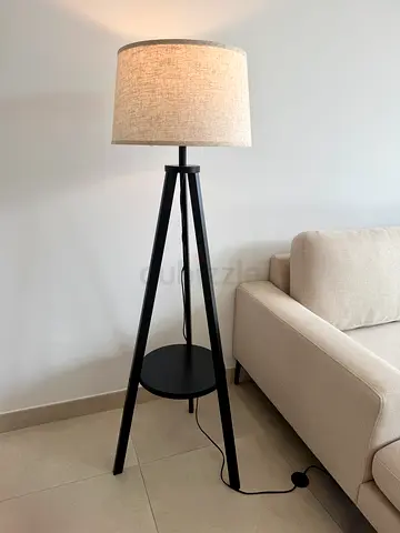 Black Tripod Floor Lamp with beige linen shade and shelf