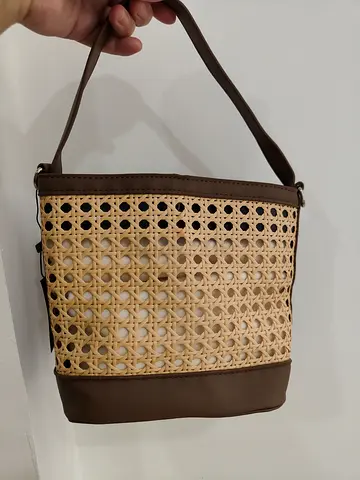 Brown woven rattan-style shoulder bag with leather trim