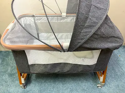 Grey bedside bassinet / cradle with canopy and wheels - best condition. It’s from juniors brand