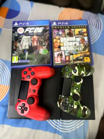 PS4 Slim with 2 DualShock 4 controllers (red + camo) and 2 games