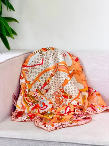 Silk-style patterned designer-inspired scarf in peach and cream tones