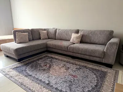 Large grey L-shaped sectional sofa with cushions - good condition