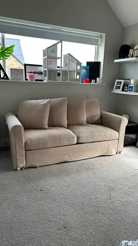 Beige 2-seater sofa bed with removable cushions — good condition