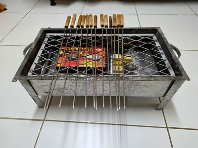 Portable charcoal barbecue grill with 12 skewers (used)