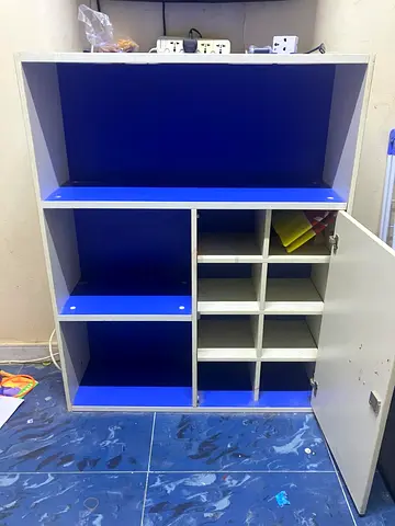 Compact white and blue storage cabinet with shelves and cubbies