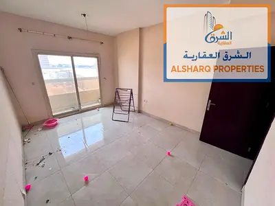 Spacious Two-Bedroom Apartment with Living Room in Al Jurf 2, next to Delta Center, featuring a separate living room, master bedroom, central AC, and