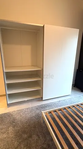 White sliding-door wardrobe with shelves — good condition