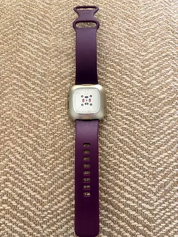 Purple Fitbit Versa-style smartwatch / fitness tracker (used)