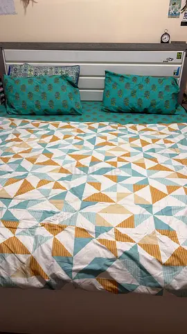 Queen bed with mattress and patterned bedding set