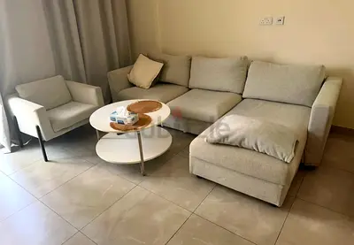 L-shaped fabric sofa bed with single armchair - good condition