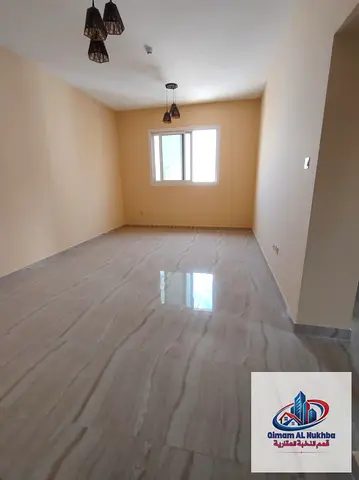 Second-occupancy 2BR in Al Nad, modern tower, central AC & parking included. AED 42K, 4/6 payments.