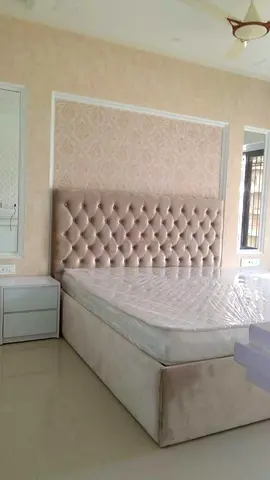 Beige upholstered queen bed with padded headboard