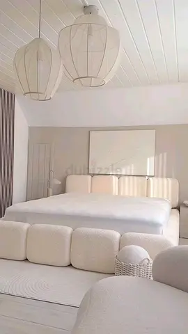 Beige upholstered queen bed with padded headboard