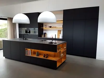 Modern matte black kitchen island with built-in shelving and full wall cabinetry