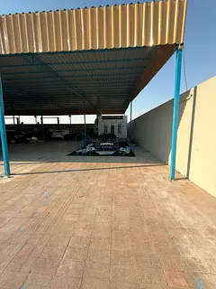 For sale: A new walled industrial plot in Sajaa Industrial Area, measuring 10,000 square feet, with