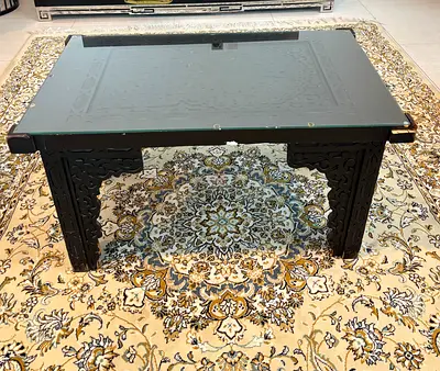 Solid wood coffee table with glass top - carved design