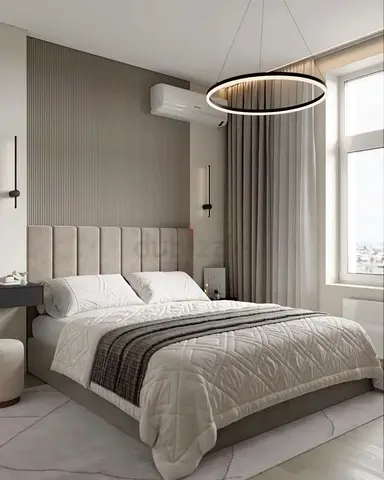 Modern upholstered bed with quilted bedding in neutral tones