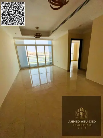 2BR hall in Al Rawda 2, opposite Kanz Mall, spacious layout with central AC, balcony, two bathrooms