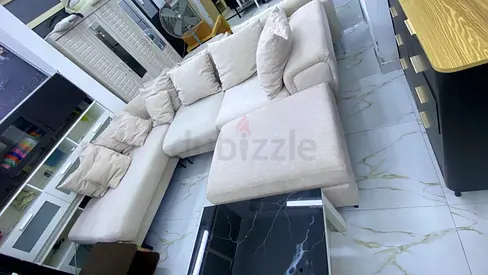Light beige L-shaped fabric sectional sofa with ottoman - good condition
