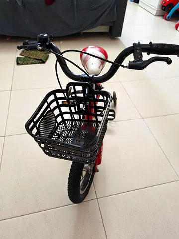 Children's red bicycle with front basket and training wheels - good condition