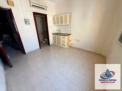 Studio in Al Bu Tina with split AC and central gas, prime location close to services. AED 12K yearly