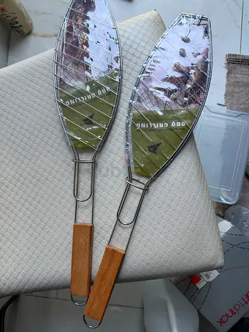 Pair of fish grilling baskets with wooden handles