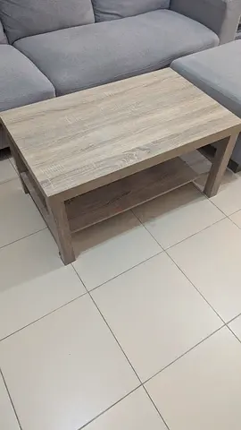 Used light wood coffee table with lower shelf - good condition
