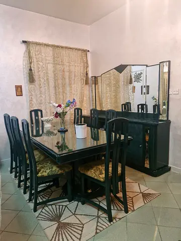 Solid dark green wood 8-seater dining table with matching buffet and chairs