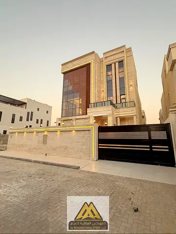 Luxury villa, first occupancy, 6 master bedrooms and swimming pool in Al Alia area, strategic location directly on Sheikh Mohammed Bin Zayed Road