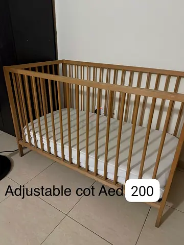 Adjustable wooden baby cot with mattress - good condition