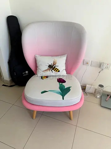 Pink gradient lounge chair with matching ottoman and floral cushion