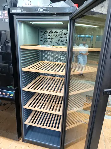 Tall stainless steel wine cooler with glass door - good condition