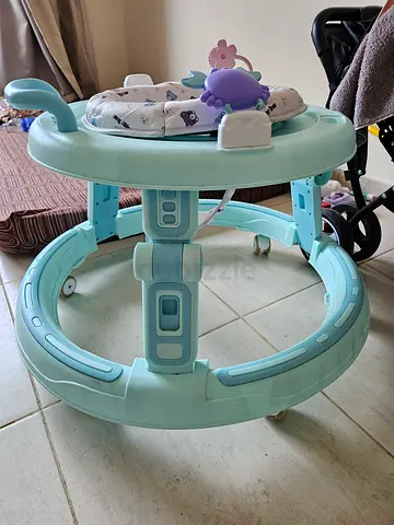 Light blue baby walker with activity toys - good condition