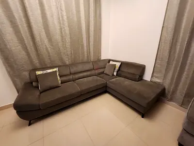 L-shaped green fabric corner sofa