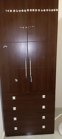 Dark wood 4-drawer wardrobe with double doors — good condition