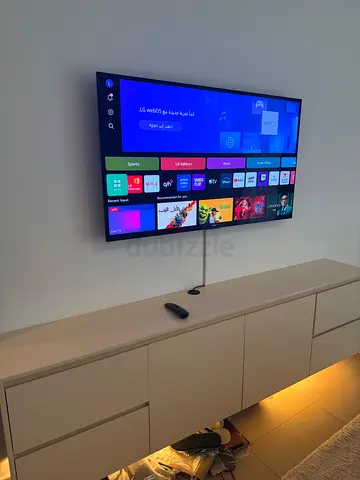 LG 55-inch Smart OLED TV mounted on wall - good condition