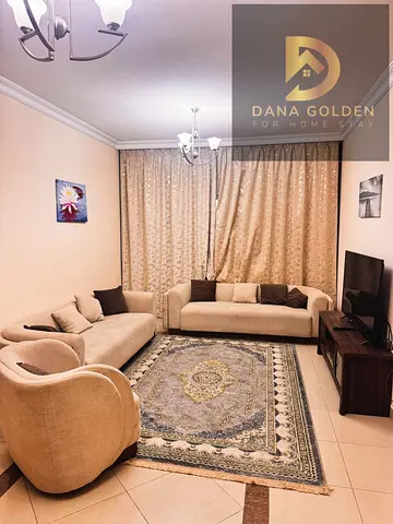 Furnished one-bedroom apartment with living room, two bathrooms, two balconies, and internet access for monthly rent in Sharjah, Al Taawun area.