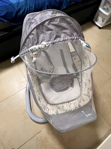Almost never used baby rocker/crib sleeper with canopy and mosquito net