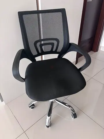Black office chair with armrests and chrome base for work and school