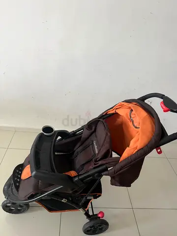 Lightly used orange and brown baby stroller - good condition