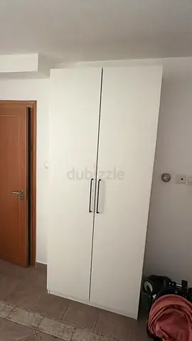 White two-door wardrobe in good condition, tall storage cabinet
