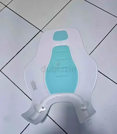Baby bath support/seat — great to bathe over the sink. Barely used. Pickup from Al Reem Island