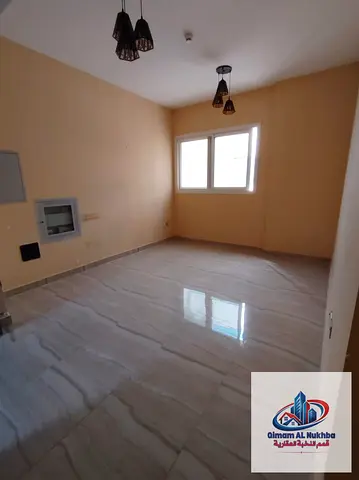 Second-occupancy 1BR in Al Nad, modern tower, central AC & free parking. AED 34K incl. parking.