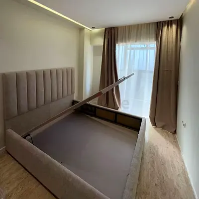 Queen upholstered storage bed frame in beige with hydraulic lift