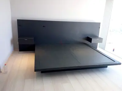 Modern low-profile king bed frame with attached bedside tables
