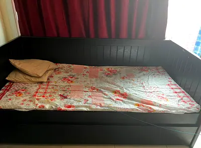 Single size bed with additonal pullout bed below with wheels — solid dark wood, good condition