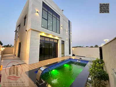 Villa for sale in Ajman, Al Zahiyah, including registration. 4 master bedrooms, majlis, living room, swimming pool, and maid's room. Open to all natio