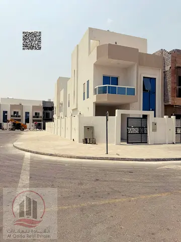 Townhouse for sale in Ajman, Al Helio area, including registration fees, electricity, and water. Features 4 master bedrooms, a majlis, and a living ro