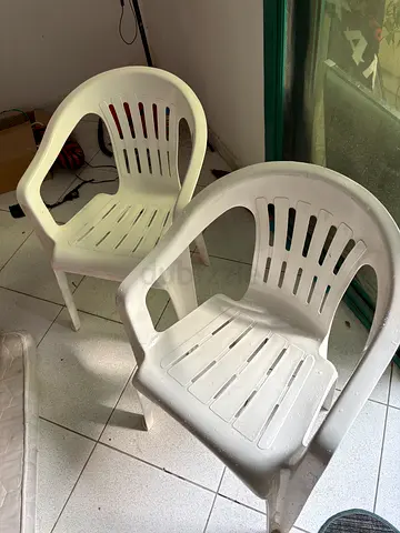 Two white plastic outdoor chairs - used, sturdy